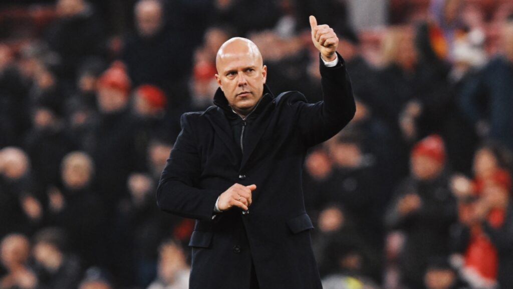 Unstoppable Reds: Liverpool's Perfect Run in the 2024-2025 Champions League. 1 Liverpool's Arn Slot Waving