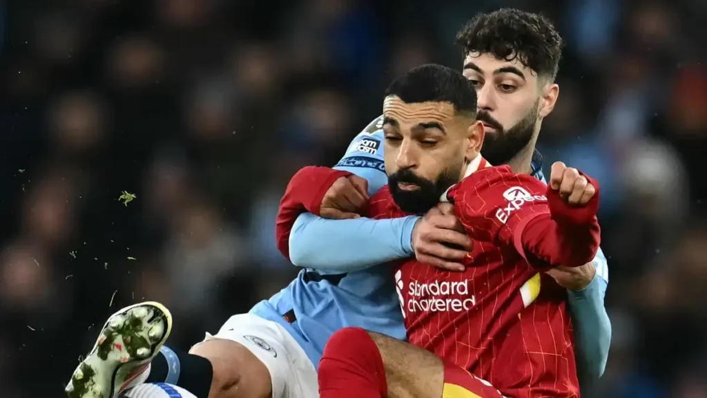 Dominant Liverpool Humiliate Manchester City: Salah and Szoboszlai Shine as Reds Extend Premier League Lead 1 Salah in action for Liverpool against Manchester City defender